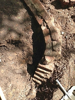 Base of the brick chimney which once ran up the hillside behind the mill